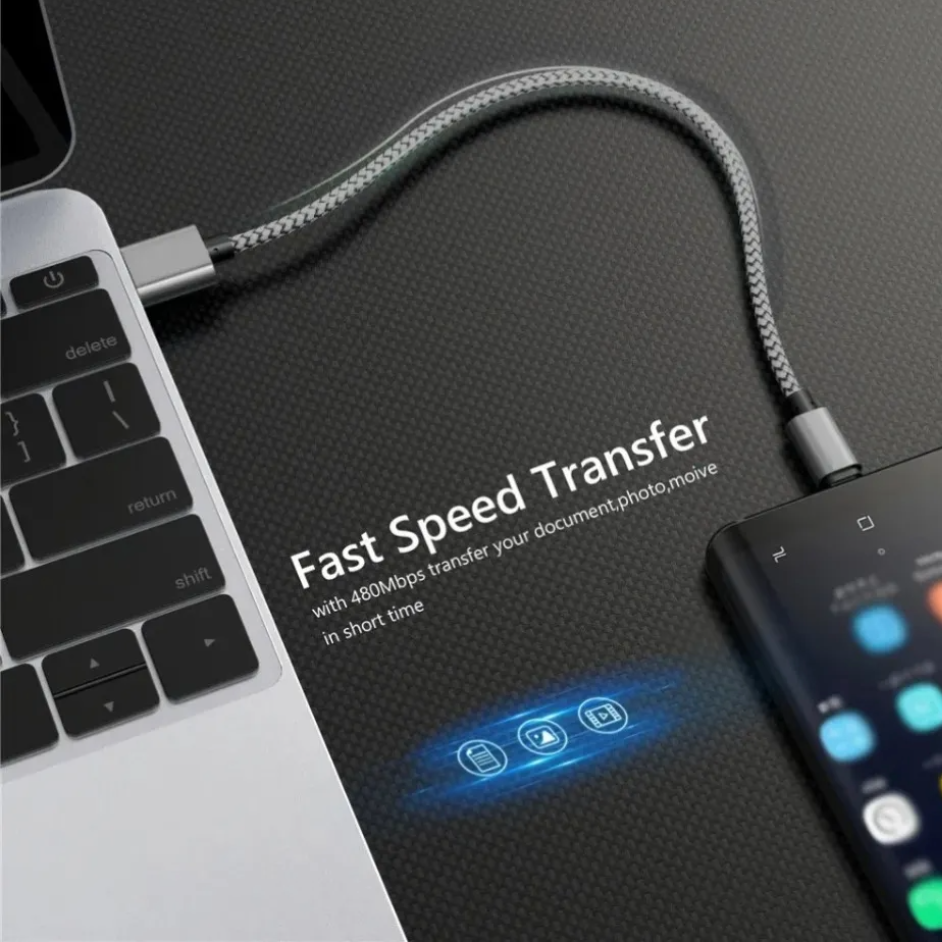 Laptop with a USB-C cable connected to a device, on a dark surface with text about fast speed transfer.